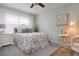 Tranquil bedroom with a floral patterned bed, white furniture, and soft lighting for a peaceful ambiance at 25008 Lalique Pl, Punta Gorda, FL 33950
