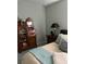 Comfortable bedroom with antique cabinet and a nightstand featuring a table lamp at 25008 Lalique Pl, Punta Gorda, FL 33950