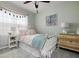 Charming bedroom featuring a white bed, vintage dresser, and soft decor creating a cozy and inviting retreat at 25008 Lalique Pl, Punta Gorda, FL 33950
