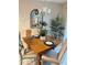 Bright dining area with wood table, stylish chairs, and decorative mirror at 25008 Lalique Pl, Punta Gorda, FL 33950