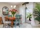 Cozy dining area with wood table, stylish chairs, and bright natural light from sliding glass doors to backyard at 25008 Lalique Pl, Punta Gorda, FL 33950
