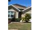 A close-up of the exterior of the home, highlighting a window and landscaping at 25008 Lalique Pl, Punta Gorda, FL 33950