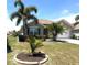 Lovely home with a manicured lawn, palm trees, and an attached two-car garage at 25008 Lalique Pl, Punta Gorda, FL 33950