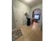 Hallway leading to kitchen, featuring neutral tile and view of appliances at 25008 Lalique Pl, Punta Gorda, FL 33950