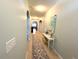 Inviting hallway with arched doorways, neutral paint, decorative runner, and accent table at 25008 Lalique Pl, Punta Gorda, FL 33950