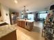 Open kitchen featuring a large island, stainless steel appliances, and seamless transition to the living area at 25008 Lalique Pl, Punta Gorda, FL 33950