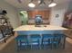Bright kitchen with an oversized island featuring seating, ample counter space, and stainless steel appliances at 25008 Lalique Pl, Punta Gorda, FL 33950