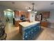 Bright kitchen with a large island, stainless steel appliances, and a view of the hallway at 25008 Lalique Pl, Punta Gorda, FL 33950