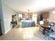 Open floor plan featuring kitchen with large island, seating, and easy flow to the dining area at 25008 Lalique Pl, Punta Gorda, FL 33950