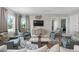 Stylish living room with comfortable seating, large windows, and modern decor; cozy and chic at 25008 Lalique Pl, Punta Gorda, FL 33950