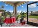 Relaxing screened patio featuring tile floor, views of landscaped yard, and comfortable seating area at 25008 Lalique Pl, Punta Gorda, FL 33950