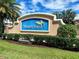 Waterford community sign with lush landscaping, palm trees, and blue sky at 25008 Lalique Pl, Punta Gorda, FL 33950