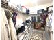 Organized walk-in closet with shelving, hanging racks, and storage containers for optimal storage at 25008 Lalique Pl, Punta Gorda, FL 33950