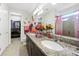Stylish bathroom boasts a double vanity, granite countertops, and a seamless glass shower at 2515 Sherman Oak Dr, North Port, FL 34289