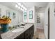 Bathroom featuring a granite countertop, dark cabinets, oval sink, and decorative wall art with modern lighting fixtures at 2515 Sherman Oak Dr, North Port, FL 34289
