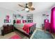 Bedroom featuring a wooden bed frame, decorated with pink accents and stylish lighting that creates a cozy atmosphere at 2515 Sherman Oak Dr, North Port, FL 34289