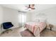Bedroom featuring a window, bed, and chair creating a serene and cozy atmosphere for relaxation and restful sleep at 2515 Sherman Oak Dr, North Port, FL 34289