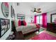 Bedroom featuring a wooden bed frame, pink accents, and natural light from the window creating a cozy atmosphere at 2515 Sherman Oak Dr, North Port, FL 34289