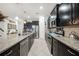 Spacious kitchen featuring stainless steel appliances, granite countertops, and tile flooring at 2515 Sherman Oak Dr, North Port, FL 34289
