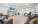 Spacious living room featuring a large TV, desk, tiled flooring, and comfortable seating creating an inviting area at 2515 Sherman Oak Dr, North Port, FL 34289