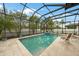 Lush screened-in pool area featuring a sun-drenched pool and comfortable seating for ultimate relaxation at 2515 Sherman Oak Dr, North Port, FL 34289