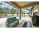 Inviting screened-in pool area featuring a cozy seating area and fire pit, perfect for outdoor entertaining at 2515 Sherman Oak Dr, North Port, FL 34289