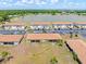Scenic aerial view of lakeside condos featuring well-maintained lawns and convenient parking at 25275 Rampart Blvd # 1504, Punta Gorda, FL 33983
