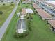 Aerial view of condo community with pool, bocce ball court, manicured lawns and mature landscaping at 25275 Rampart Blvd # 1504, Punta Gorda, FL 33983