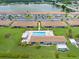 Aerial view of waterfront condos featuring a community pool, well-manicured lawns and ample parking at 25275 Rampart Blvd # 1504, Punta Gorda, FL 33983