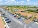 Low aerial view of condo complex with palm trees, well maintained landscaping, and ample parking at 25275 Rampart Blvd # 1504, Punta Gorda, FL 33983