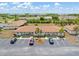 Aerial view of condo complex showing parking, palm trees, and manicured landscaping at 25275 Rampart Blvd # 1504, Punta Gorda, FL 33983
