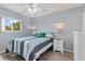 Inviting bedroom with a striped quilt, white furniture, and a bright window at 25275 Rampart Blvd # 1504, Punta Gorda, FL 33983