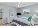 Tranquil bedroom with a striped quilt, white furniture, and a bright window view at 25275 Rampart Blvd # 1504, Punta Gorda, FL 33983