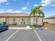 Charming single-story condo with manicured lawn, palm tree, and convenient parking at 25275 Rampart Blvd # 1504, Punta Gorda, FL 33983