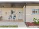 Charming front porch with seating area, perfect for relaxing and enjoying the neighborhood ambiance at 25275 Rampart Blvd # 1504, Punta Gorda, FL 33983