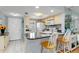 Well-lit kitchen featuring a breakfast bar with seating and neutral cabinetry at 25275 Rampart Blvd # 1504, Punta Gorda, FL 33983