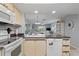 Functional kitchen with white cabinetry and a view into the dining and living areas at 25275 Rampart Blvd # 1504, Punta Gorda, FL 33983