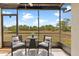 Relaxing screened lanai with comfortable seating and a view of the lush green landscape at 25275 Rampart Blvd # 1504, Punta Gorda, FL 33983