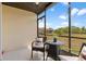Screened lanai offers a cozy seating area with peaceful outdoor views of the lawn and sky at 25275 Rampart Blvd # 1504, Punta Gorda, FL 33983