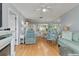 Bright and open living space with hardwood floors, comfortable seating, and a seamless flow to dining and kitchen areas at 25275 Rampart Blvd # 1504, Punta Gorda, FL 33983