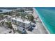 Stunning aerial view of beachfront building with pristine beach, showcasing coastal living and nearby attractions at 2590 N Beach Rd # 5, Englewood, FL 34223