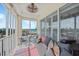 Relaxing sunroom featuring a comfortable daybed, seating, and views of the ocean, perfect for coastal living at 2590 N Beach Rd # 5, Englewood, FL 34223