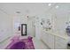 Elegant bathroom featuring a double vanity, glass-enclosed shower, and charming decor, offering a serene retreat at 2590 N Beach Rd # 5, Englewood, FL 34223