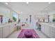 Bright bathroom with double vanity, soaking tub, and charming decor, creating a relaxing and stylish space at 2590 N Beach Rd # 5, Englewood, FL 34223