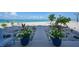 Scenic wooden boardwalk leading to the beach, framed by lush landscaping and blue ocean views at 2590 N Beach Rd # 5, Englewood, FL 34223