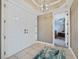 Elegant foyer features a chandelier and double doors leading to a bedroom, offering a stylish entry at 2590 N Beach Rd # 5, Englewood, FL 34223