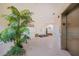 Inviting hallway with modern decor, a charming plant, and convenient elevator access at 2590 N Beach Rd # 5, Englewood, FL 34223