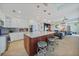 Open concept kitchen features a large island with seating, stainless steel appliances, and modern lighting fixtures at 2590 N Beach Rd # 5, Englewood, FL 34223