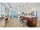 Spacious kitchen featuring a large island with seating, stainless steel appliances, and a seamless connection to the living area at 2590 N Beach Rd # 5, Englewood, FL 34223