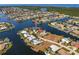 Aerial view of a waterfront property surrounded by canals and lush landscaping in a beautiful residential neighborhood at 261 Venezia Ct, Punta Gorda, FL 33950